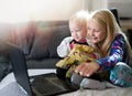 Two kids playing with laptop computer . Royalty Free Stock Photo