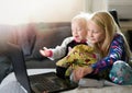 Two kids playing with laptop computer . Royalty Free Stock Photo