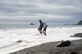 Two kids playing on Rialto Beach Olympic National Washington