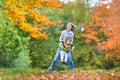 Two kids playing togeter in autumn park Royalty Free Stock Photo