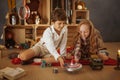 Two Kids Playing With Toys Near the Christmas Tree