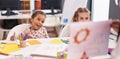 Two kids preschool students having lesson with teacher at classroom