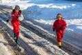 Two kids in rainboots running on the ice puddle Royalty Free Stock Photo