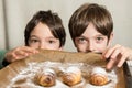 Two kids reaching for freshly baked spiral cookies