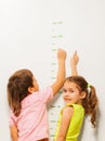 Two kids read height at home wall Royalty Free Stock Photo