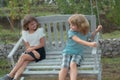 Two kids relaxing outdoors at summer park. Brother and sister happy walking in nature. Siblings boy and girl playing in Royalty Free Stock Photo