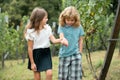 Two kids relaxing outdoors at summer park. Brother and sister happy walking in nature. Siblings boy and girl playing in Royalty Free Stock Photo