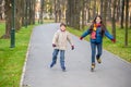 Two kids riding in autumn park on rollerblades Royalty Free Stock Photo