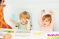 Two kids show weather cards sitting in the kindergarten class Royalty Free Stock Photo