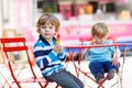 Two kids - sibling boys eating colorful ice cream in summer Royalty Free Stock Photo