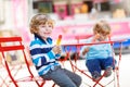 Two kids - sibling boys eating colorful ice cream in summer Royalty Free Stock Photo