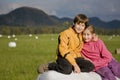 Two kids sitting on a hay bale Royalty Free Stock Photo