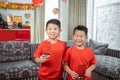 Two kids smile in red shirts with angpau Royalty Free Stock Photo