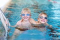 Two kids swimming in the pool Royalty Free Stock Photo