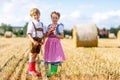 Two kids, boy and girl in traditional Bavarian costumes in wheat field Royalty Free Stock Photo