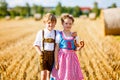 Two kids, boy and girl in traditional Bavarian costumes in wheat field Royalty Free Stock Photo