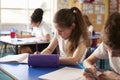 Two kids working at their desks in primary school, crop shot Royalty Free Stock Photo