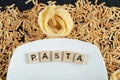 Two kinds of pasta scattered around white plate