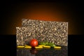 Two kitchen granite countertop samples standing on glossy black table with food decoration. Kitchen countertop concept.