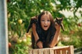 Two kittens in hands. Little girl is in the garden with tomatoes Royalty Free Stock Photo