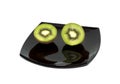 Two kiwis on a black plate, the top view Royalty Free Stock Photo