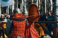 Two knights fight each other with swords. Festival of jousting tournaments. Royalty Free Stock Photo