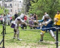 Two knights with halberds fight in the ring at the Purim festival with King Arthur in the city of Jerusalem, Israel