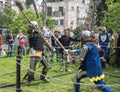 Two knights with halberds fight in the ring at the Purim festival with King Arthur in the city of Jerusalem, Israel