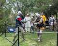 Two knights with swords fight in the ring at the Purim festival with King Arthur in Jerusalem city, Israel