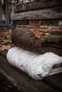 Two knitted sweaters on a wooden city bench under fallen oak leaves Royalty Free Stock Photo