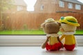Two knitting dolls girl and boy holding hand sitting next to the window Royalty Free Stock Photo