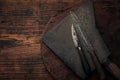 Two knives on a big rusty cleaver on top of a rustic table top Royalty Free Stock Photo