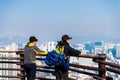 Two Korean men looking at the downtown of Seoul City at the view platform at the Namsan Mountain in winter in south central