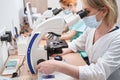 Ladies working in the laboratory with microscopes Royalty Free Stock Photo