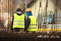 Two labours in yellow at the construction site Royalty Free Stock Photo