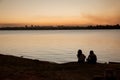 Two Ladies Enjoying the Sunset a the Lake Royalty Free Stock Photo