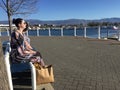 Two ladies sitting on park bench in springtime