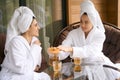 Cheerful females in white robes after spa treatments Royalty Free Stock Photo