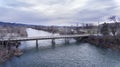 Drone shot of a bridge going over water during the winter time Royalty Free Stock Photo