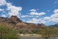 a highway curves past a scenic mountain range in the desert Royalty Free Stock Photo