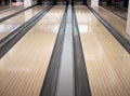 Two lanes tracks at bowling club with bunch of bowls pins at far distance. low angle image Royalty Free Stock Photo