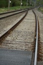 Two lanes or tracks of rails meeting in perspective into one, fusion of two rail lanes or tracks, the photo can have a symbolic me Royalty Free Stock Photo