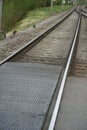 Two lanes or tracks of rails meeting in perspective into one, fusion of two rail lanes or tracks, the photo can have a symbolic me Royalty Free Stock Photo