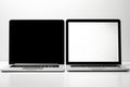 Two laptops with contrasting screens, one black and one white, displaying a minimalist design Royalty Free Stock Photo