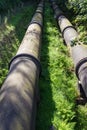 Two large black water pipes, converging in distance. Royalty Free Stock Photo