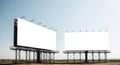 Two large blank billboards stand against a clear sky outdoors Royalty Free Stock Photo