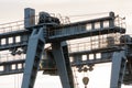 two large bridge cranes on the background of the sky at sunset. Outline of a girder crane on a cloud background. overhead cranes