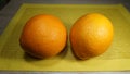 Two large bright Spanish oranges on the table