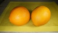 Two large bright Spanish oranges on the table