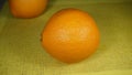 Two large bright Spanish oranges on the table